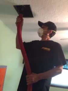 Technician cleaning ducts in Houston, TX