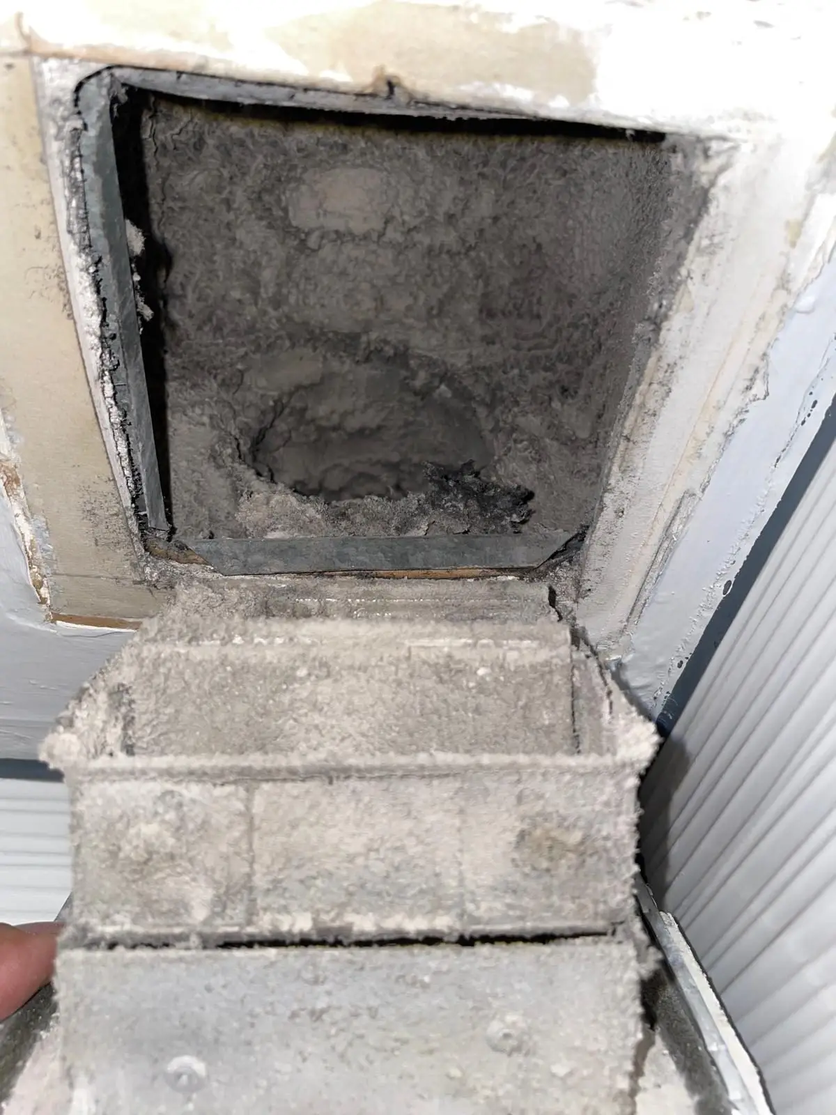 Heavily clogged dryer vent at a Houston high-rise condominium before cleaning