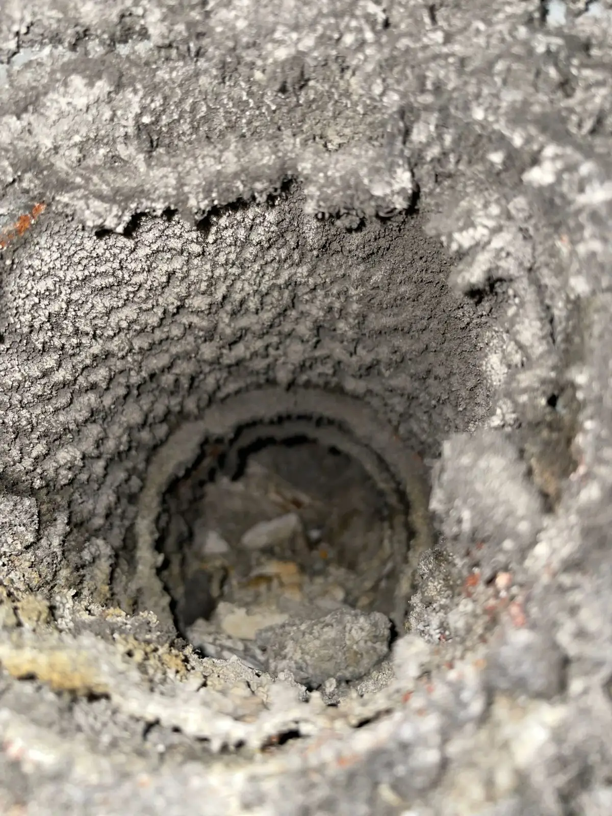 Thick lint buildup coating a dryer vent duct in a Houston condo