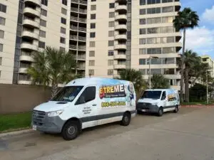 Extreme Air Duct Cleaning vans parked outside 3525 Sage Condominiums in Uptown Houston