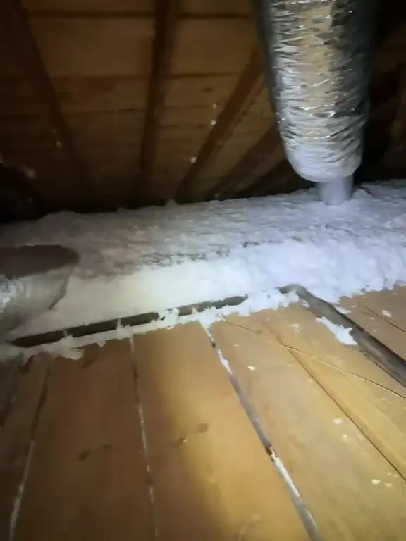 Even blown-in insulation coverage around attic ductwork in Katy, TX