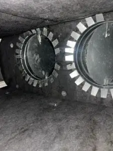 Two cleaned flex duct takeoffs in fiberboard plenum after service in Missouri City TX