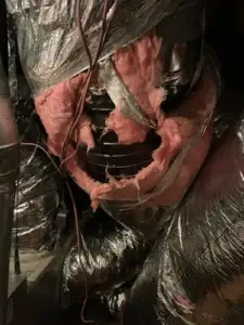 Supply duct connection stuffed with fiberglass instead of sealed, found in a Bellaire, TX attic
