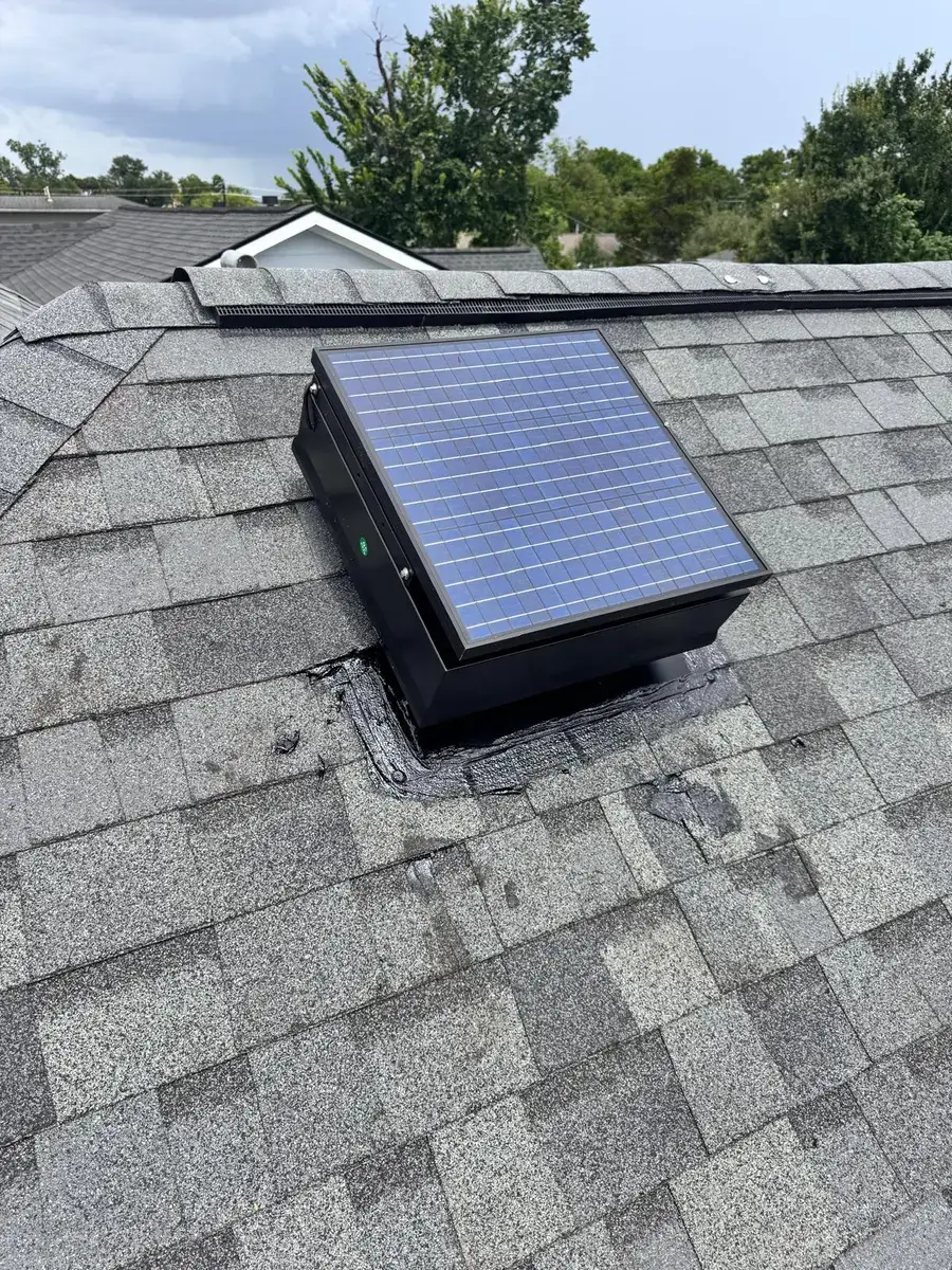 Solar-powered attic fan with its panel mounted on a Houston rooftop, sealed to the shingles