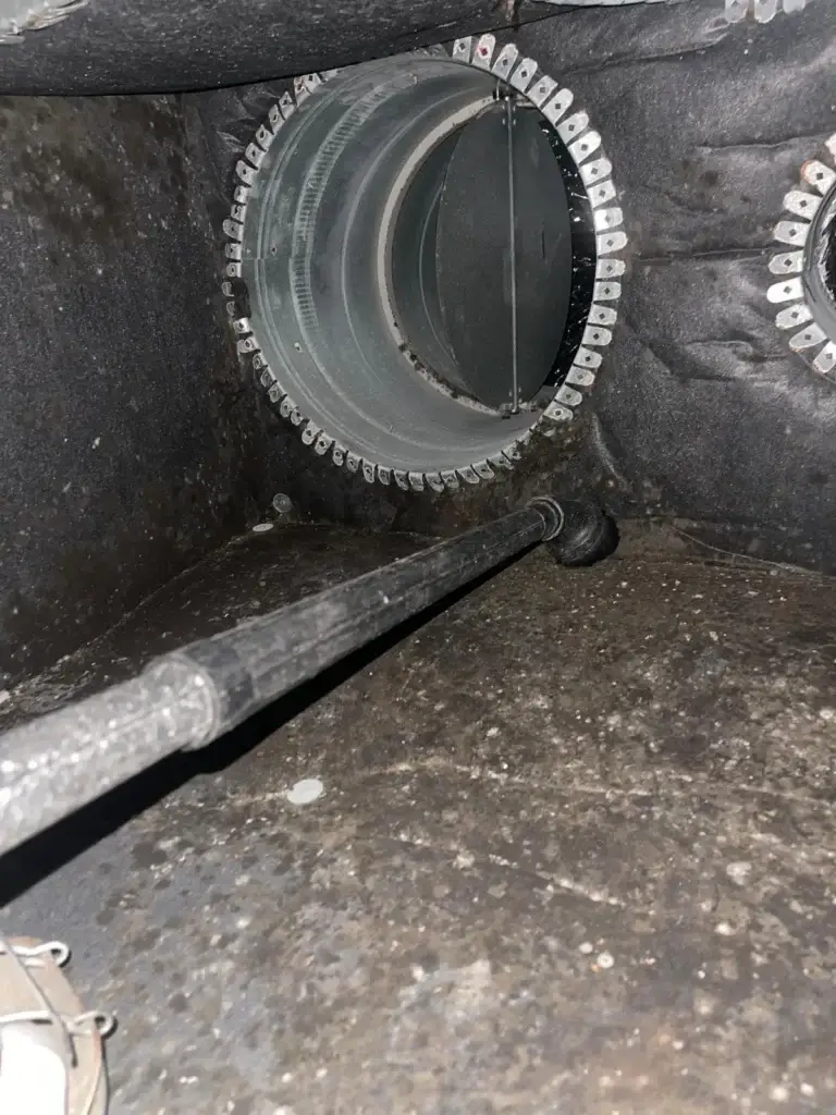 Rotor brush cleaning in progress inside a supply plenum in Bellaire, TX