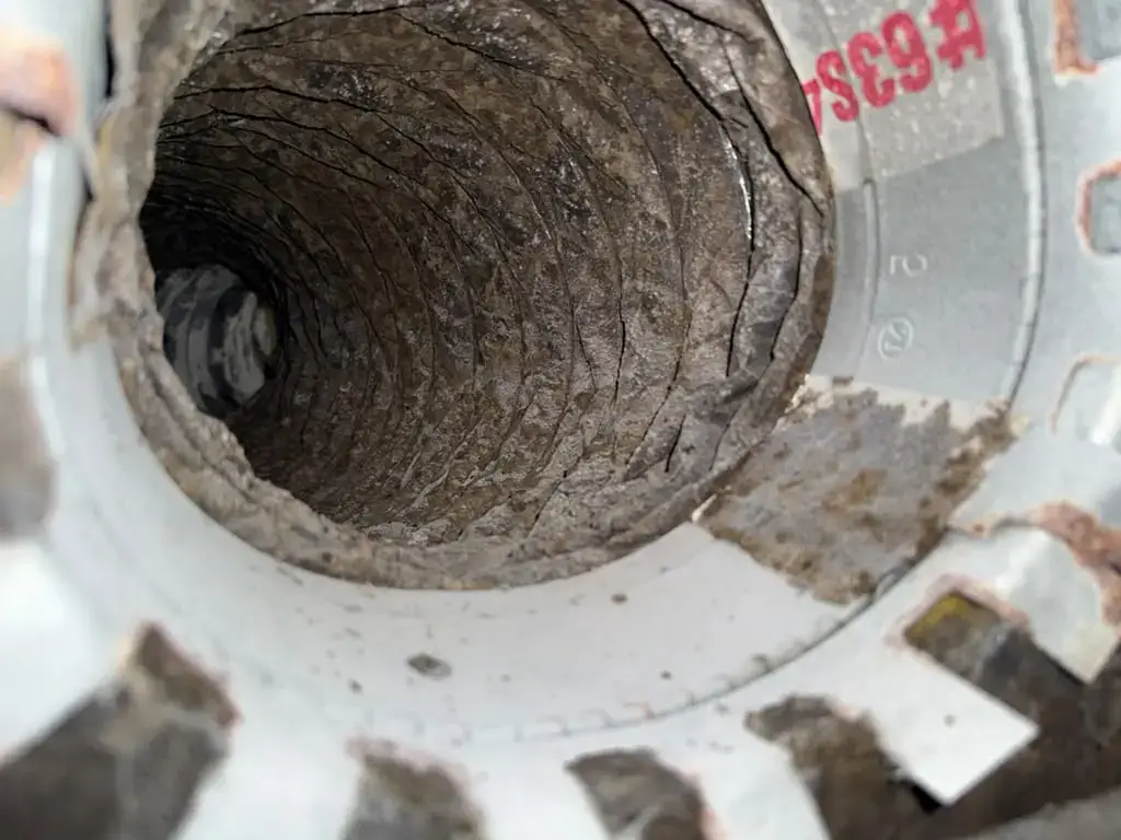 Dirty flex duct run at the collar before rotary brush cleaning in Katy, TX 77450
