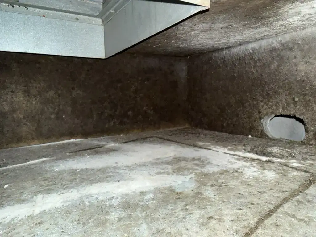 Dark buildup covering a return box interior before duct cleaning in Katy, TX
