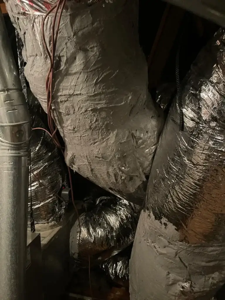 Duct trunk connections properly sealed with mastic in a Bellaire, TX attic