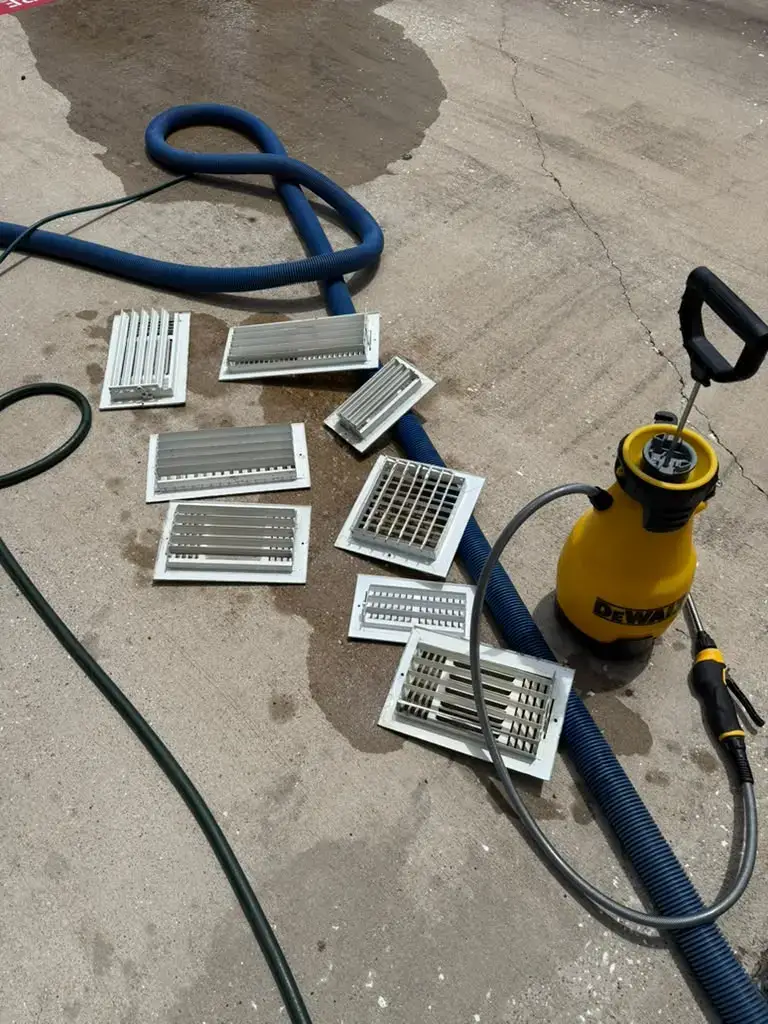 Register covers laid out for washing during duct cleaning in Katy, TX 77450