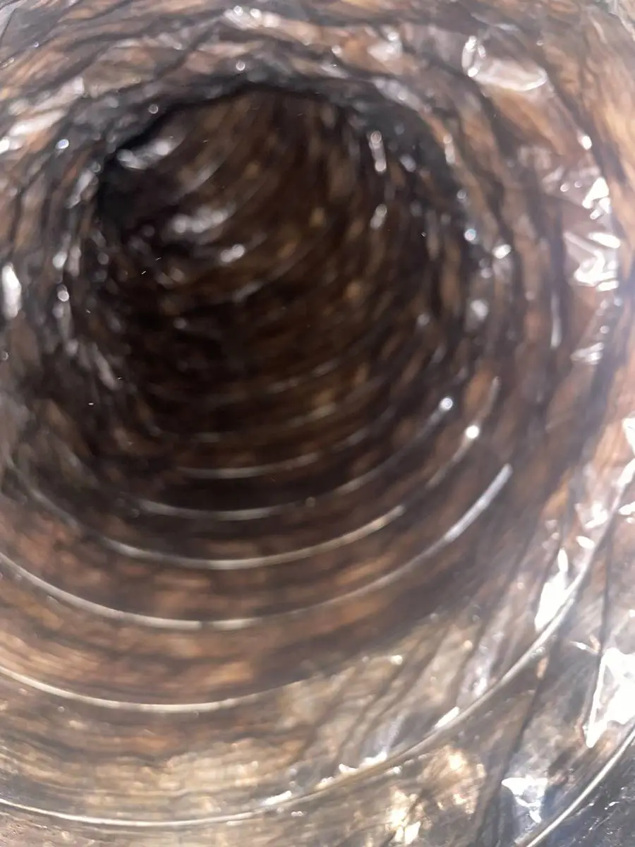 Dirty air duct interior with heavy dust buildup during air duct cleaning in Memorial Forest, Houston TX