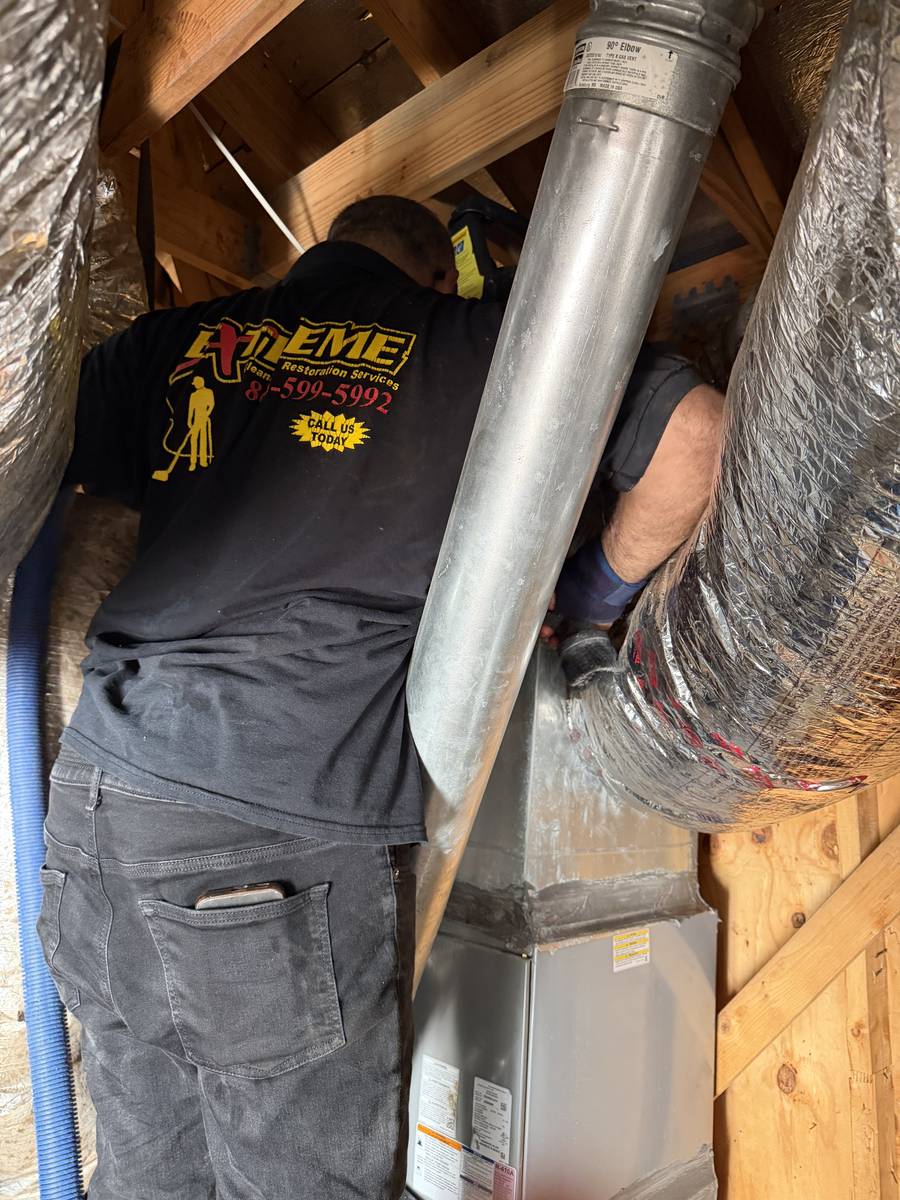 Extreme Air Duct technicians cleaning attic ductwork in Knollwood Village, Houston TX