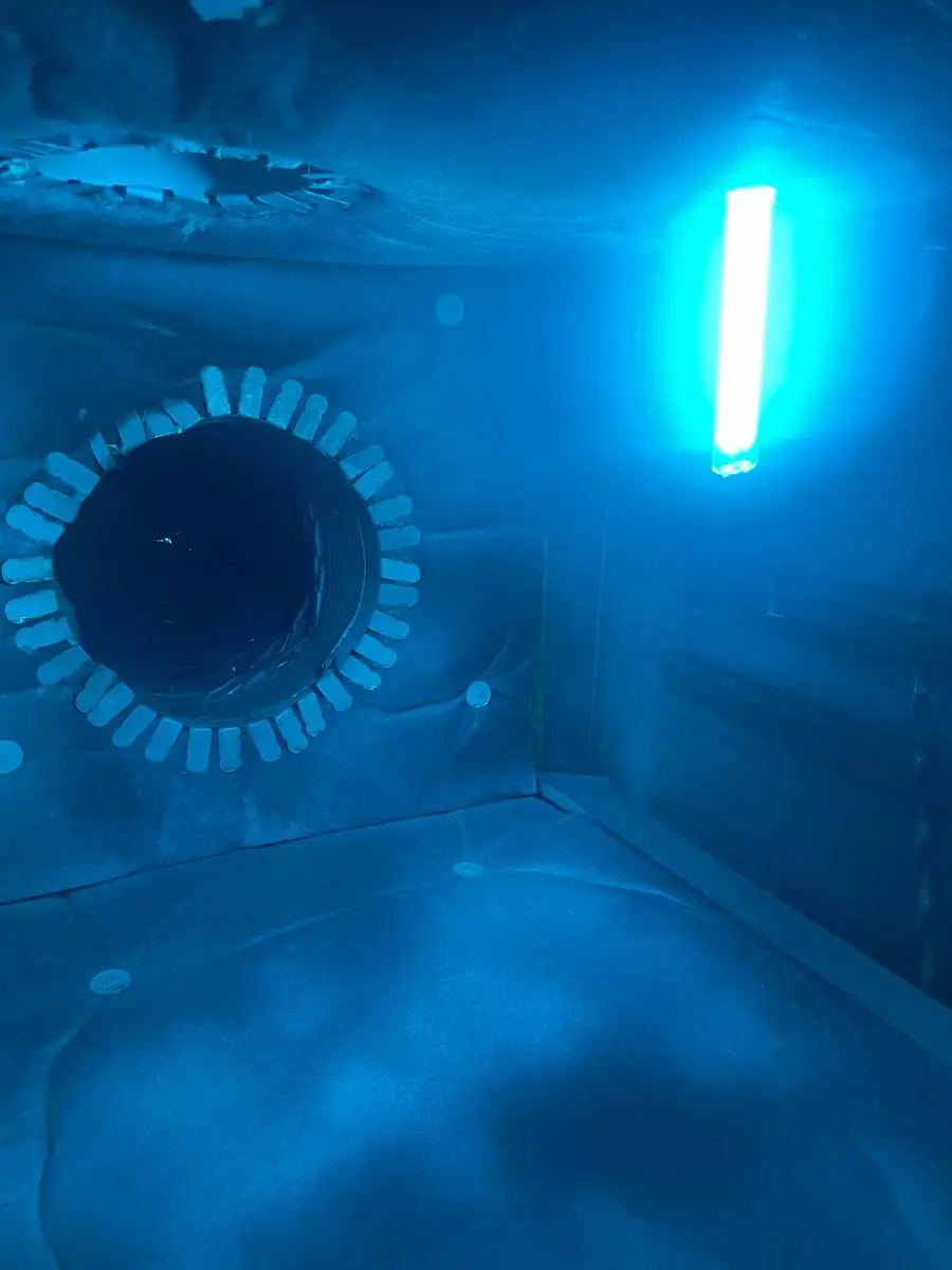 Technician using UV light to inspect ductwork during air duct cleaning in Memorial Forest, Houston TX