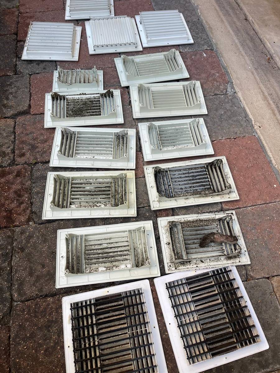 Air vent covers removed and lined up for washing during a Houston air duct cleaning