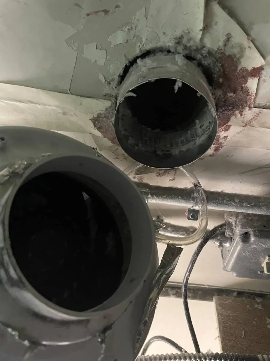 Cleared dryer vent duct connection after lint removal at a commercial laundry in Houston 77057