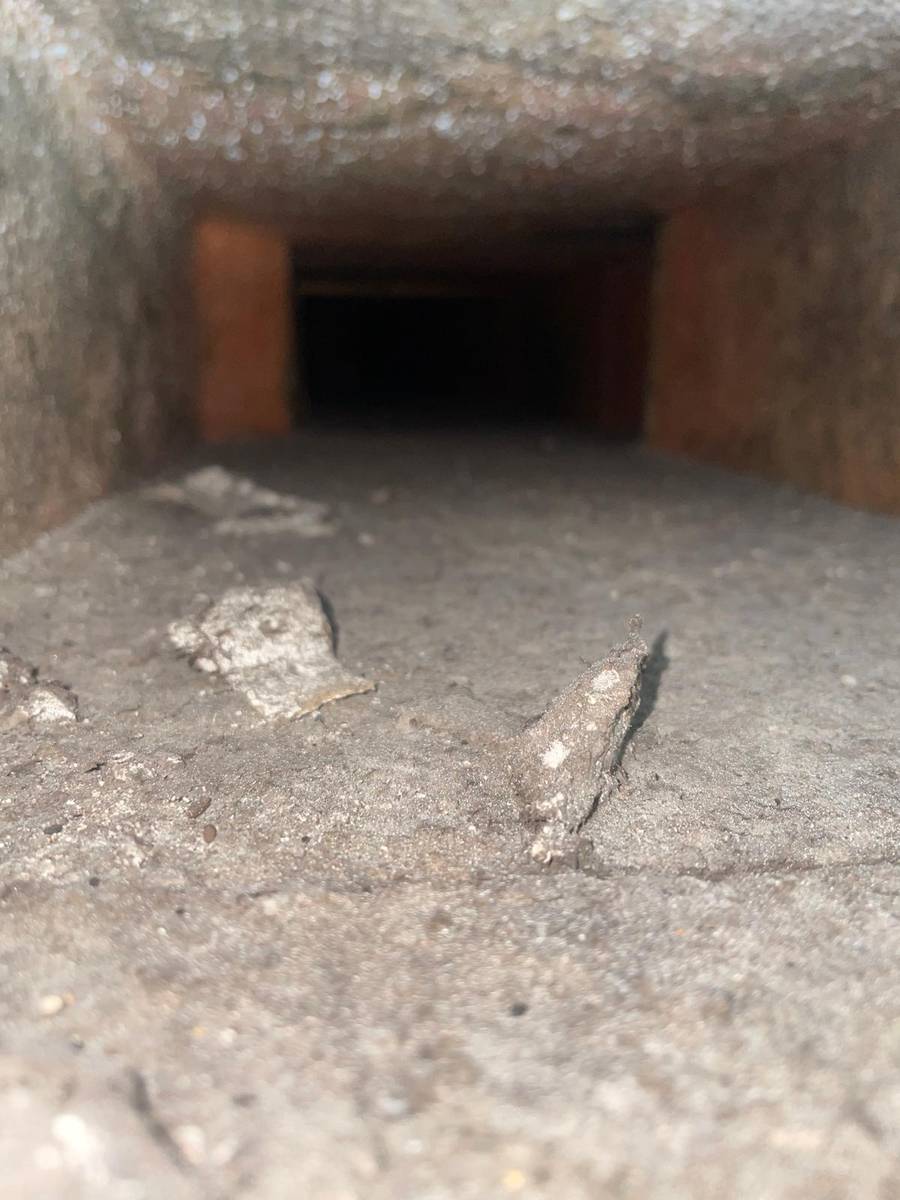 Loose debris and dust on the floor of an air duct before cleaning in Montrose, Houston 77006