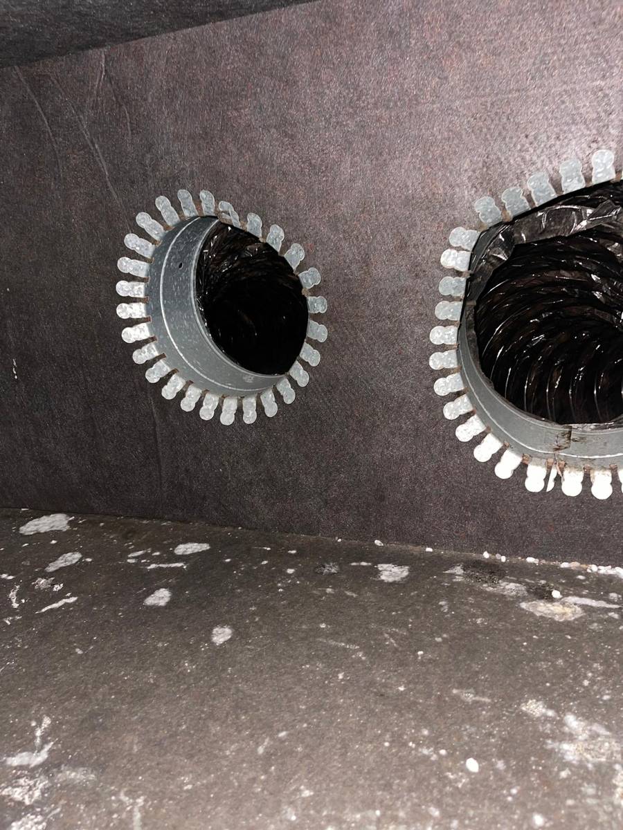 Dusty ductboard plenum wall and supply collars before cleaning in southwest Houston