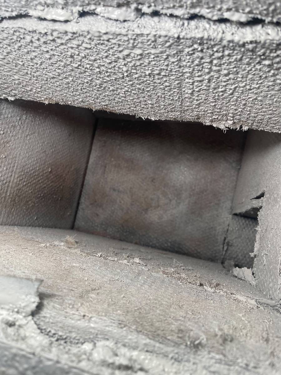 Dust-covered ductboard trunk line before air duct cleaning in Houston 77006