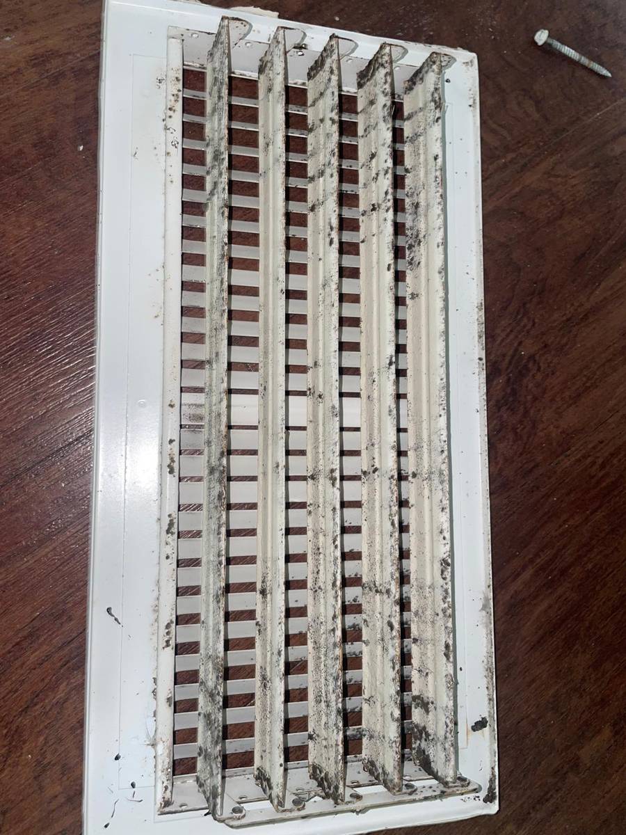 Supply air register with dark dust streaks before cleaning in Houston 77006