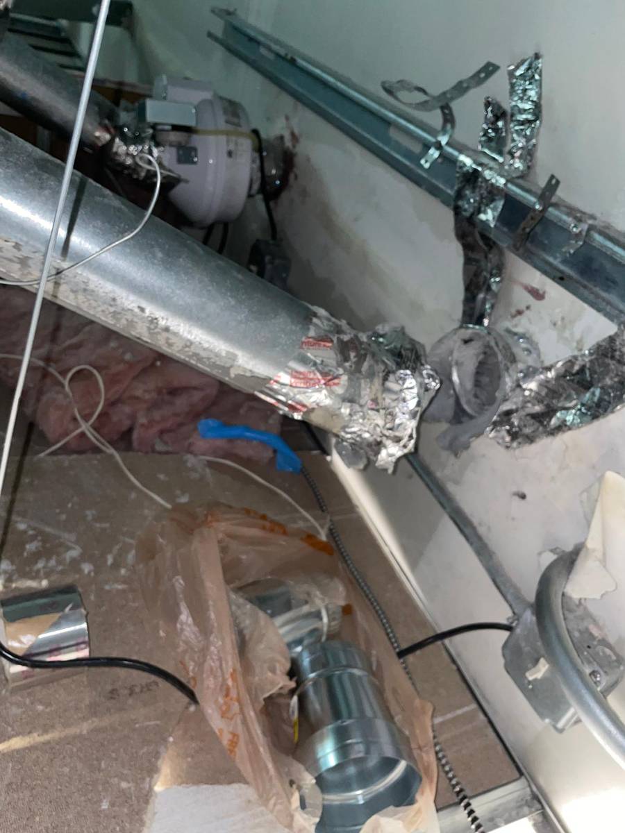 Dryer vent duct run connected to an inline booster fan above a commercial ceiling in Tanglewood