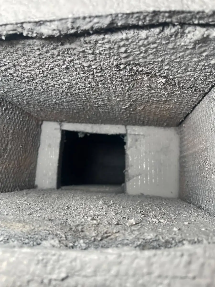 Debris collected at a duct boot connection before cleaning in Montrose, Houston 77006