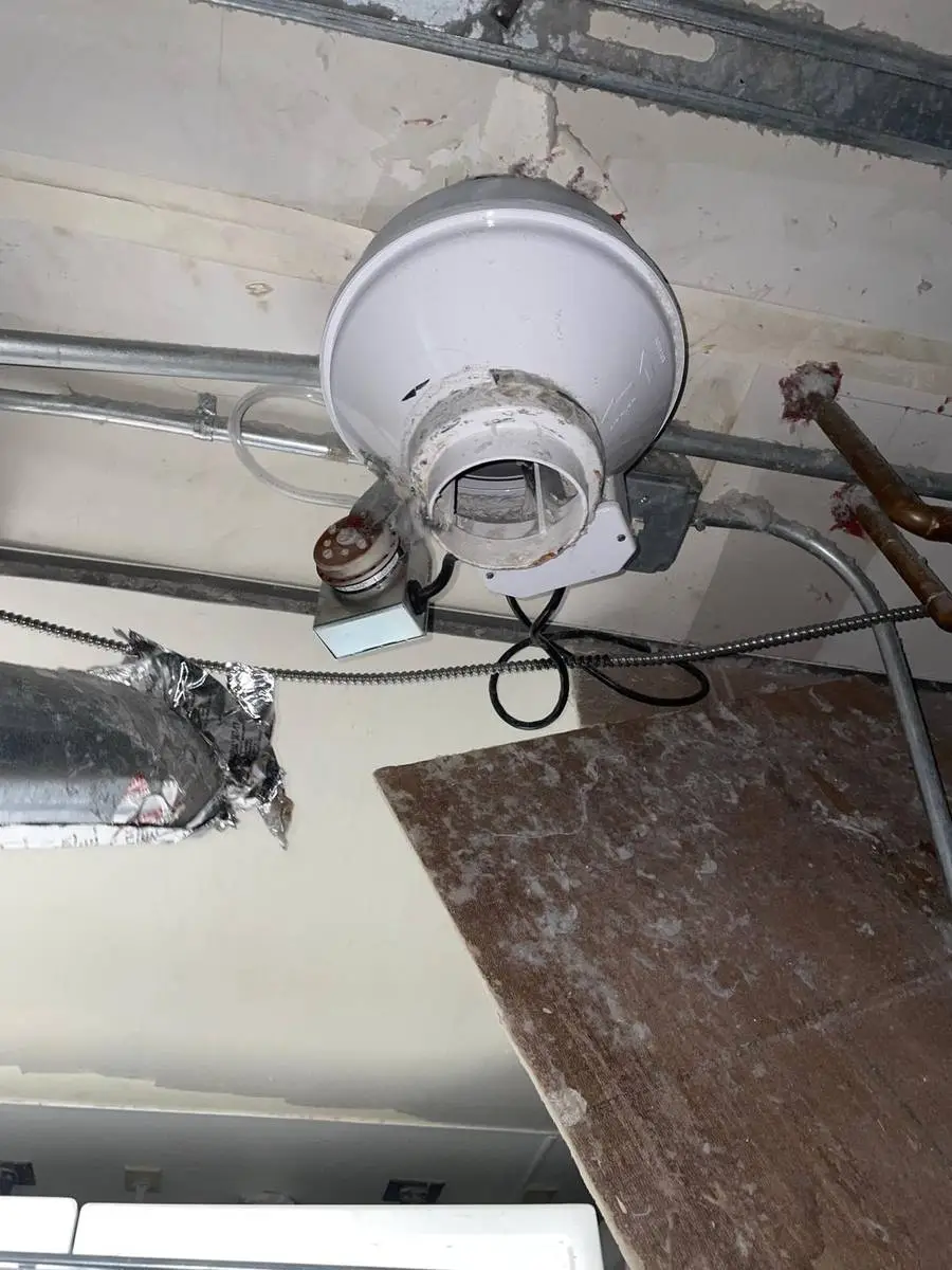 Inline dryer booster fan installed in the ceiling of a commercial laundry in Houston 77057